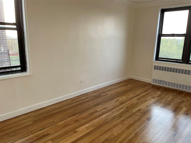150-15 72nd Rd Unit 4G, Flushing, NY 11367 - spare room featuring radiator, wood finished floors, and ornamental molding