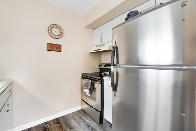 26 Cooper Rd Unit 416, Poughkeepsie, NY 12603 - kitchen with stainless steel appliances, under cabinet range hood, dark wood-style floors, light countertops, and white cabinetry