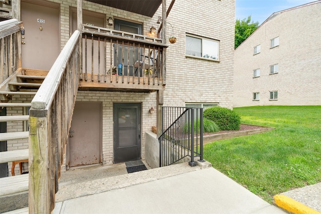 26 Cooper Rd Unit 416, Poughkeepsie, NY 12603 - property entrance featuring brick siding, a gate, a yard, and a balcony