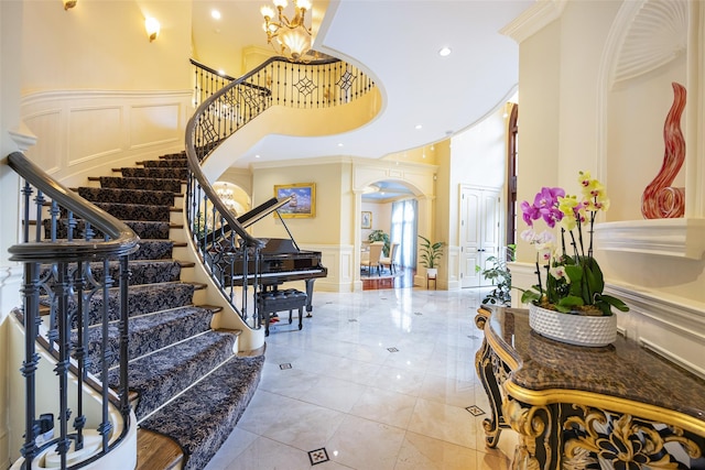 11 Black Rock Rd, Muttontown, NY 11545 - entrance foyer featuring a decorative wall, a towering ceiling, stairs, ornamental molding, and a wainscoted wall