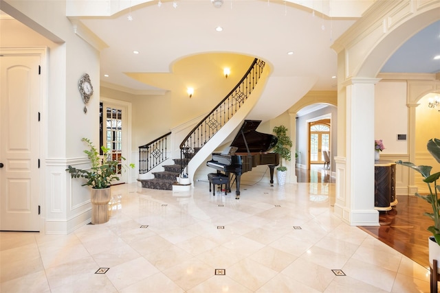 11 Black Rock Rd, Muttontown, NY 11545 - foyer entrance featuring arched walkways, ornate columns, a decorative wall, stairs, and recessed lighting