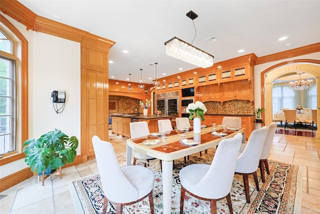 11 Black Rock Rd, Muttontown, NY 11545 - dining space featuring a chandelier, stone tile flooring, recessed lighting, and arched walkways