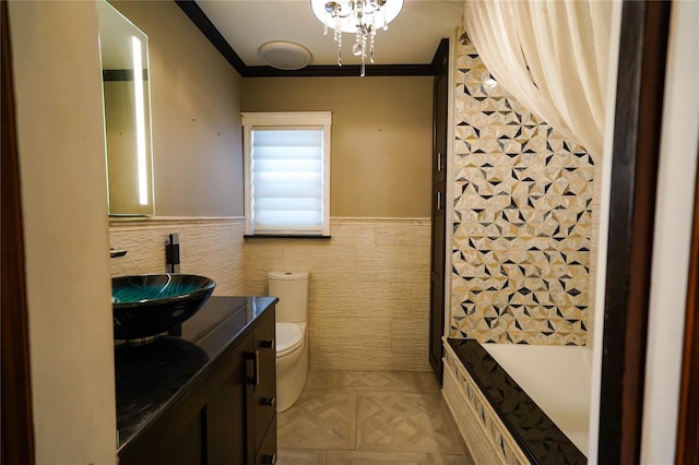 342 Mildred St, Oceanside, NY 11572 - bathroom with tile walls, vanity, crown molding, and a wainscoted wall