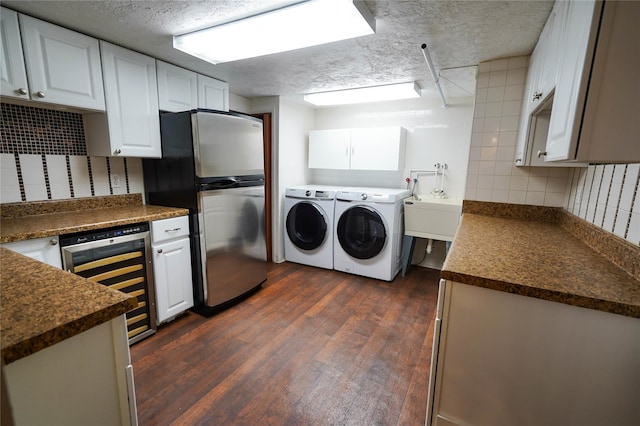 342 Mildred St, Oceanside, NY 11572 - kitchen with beverage cooler, washing machine and clothes dryer, freestanding refrigerator, dark countertops, and tasteful backsplash