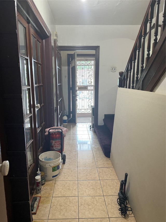 2449 92nd St, East Elmhurst, NY 11369 - hall with stairs and light tile patterned floors