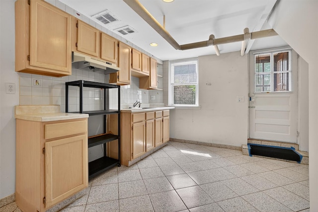 175 N Regent St, Port Chester, NY 10573 - kitchen with under cabinet range hood, plenty of natural light, backsplash, light brown cabinetry, and recessed lighting