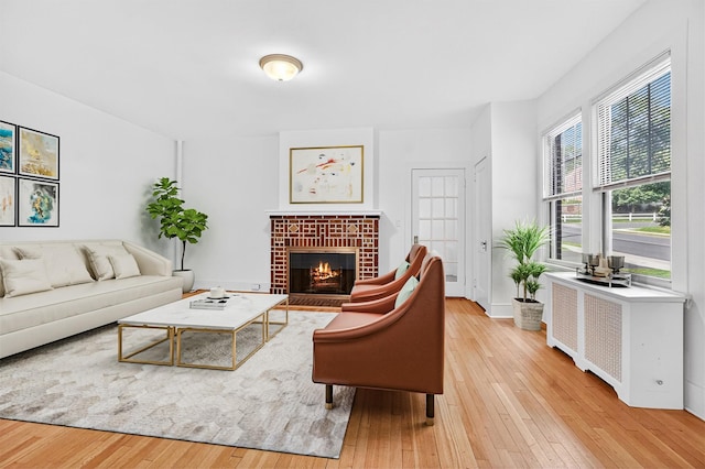 175 N Regent St, Port Chester, NY 10573 - living room featuring wood-type flooring, a fireplace, and radiator
