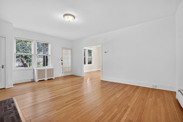 175 N Regent St, Port Chester, NY 10573 - unfurnished room with radiator, plenty of natural light, light wood-style floors, and a baseboard radiator
