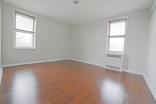 5621 Netherland Ave Unit 5C, Bronx, NY 10471 - empty room with radiator and dark wood-type flooring