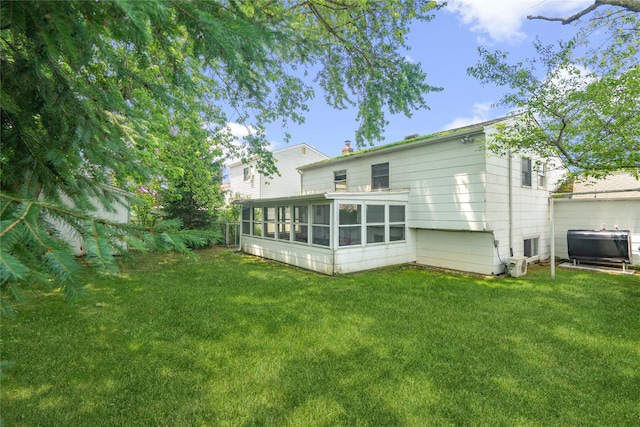 337 Atlantic Ave, Massapequa Park, NY 11762 - back of house featuring a sunroom and a yard