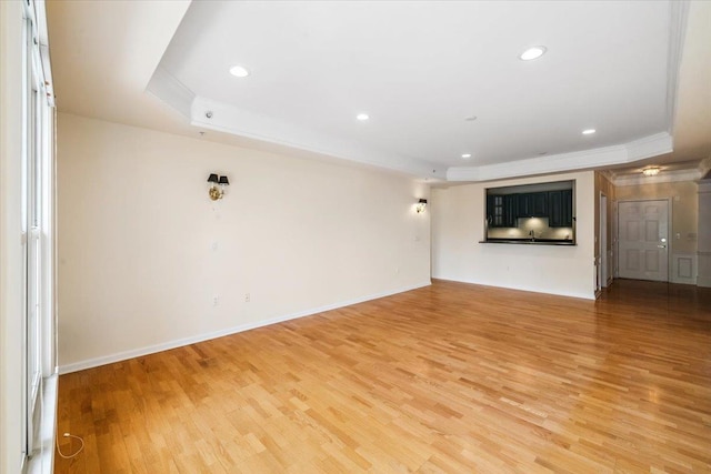 26 N De Baun Ave Unit 303, Suffern, NY 10901 - unfurnished living room with a raised ceiling, light wood-style floors, ornamental molding, and recessed lighting