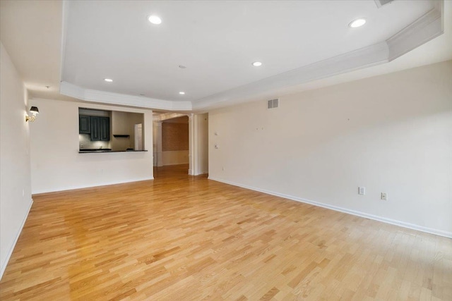 26 N De Baun Ave Unit 303, Suffern, NY 10901 - empty room featuring a tray ceiling, light wood-style floors, recessed lighting, and ornamental molding
