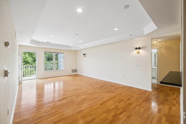 26 N De Baun Ave Unit 303, Suffern, NY 10901 - spare room featuring a raised ceiling, light wood-style floors, recessed lighting, and ornamental molding