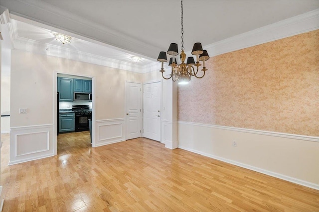 26 N De Baun Ave Unit 303, Suffern, NY 10901 - unfurnished dining area featuring a chandelier, light wood finished floors, a wainscoted wall, and crown molding