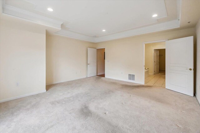 26 N De Baun Ave Unit 303, Suffern, NY 10901 - unfurnished bedroom featuring a raised ceiling, light carpet, crown molding, recessed lighting, and connected bathroom