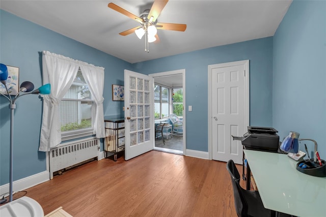 231 Wilson St, West Hempstead, NY 11552 - office area featuring radiator, ceiling fan, wood finished floors, and french doors