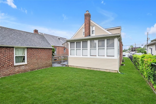 231 Wilson St, West Hempstead, NY 11552 - back of property with a chimney and brick siding
