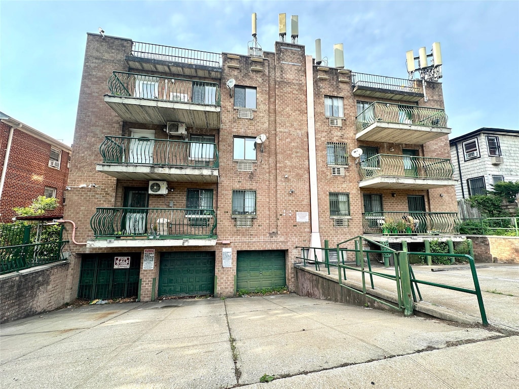 130-14 60th Ave Unit 2E, Flushing, NY 11355 - view of apartment building / complex with driveway and a garage