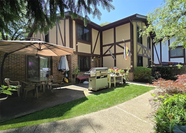 23 Birchwood Rd Unit 23, Coram, NY 11727 - back of property with stucco siding, brick siding, and a patio