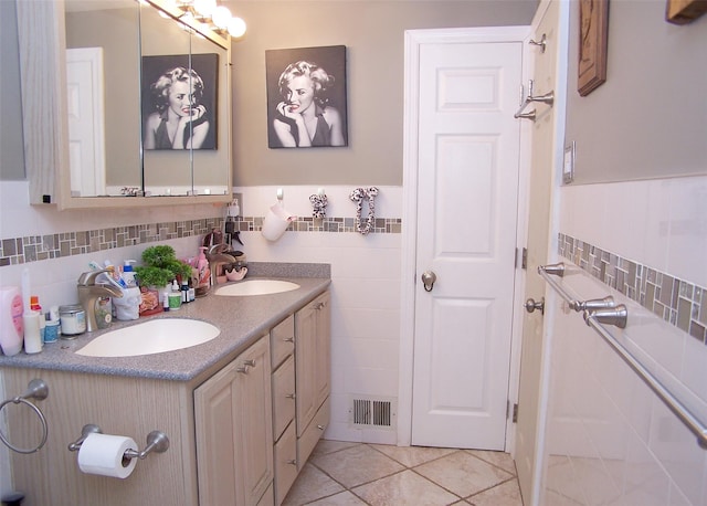 23 Birchwood Rd Unit 23, Coram, NY 11727 - bathroom with double vanity, tile walls, tile patterned flooring, and wainscoting