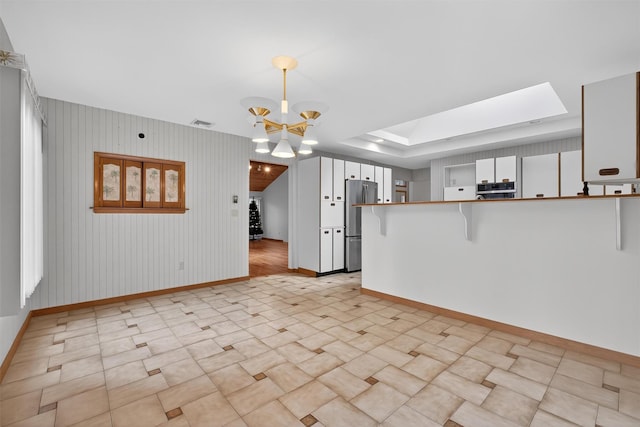 35 Greenlawn Rd, Amawalk, NY 10501 - unfurnished living room featuring a chandelier and a skylight