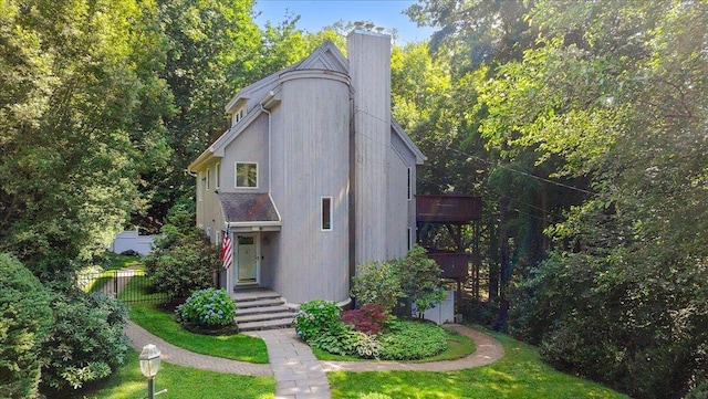 474 Swanson Dr, Thornwood, NY 10594 - view of front of home with a chimney and a view of trees