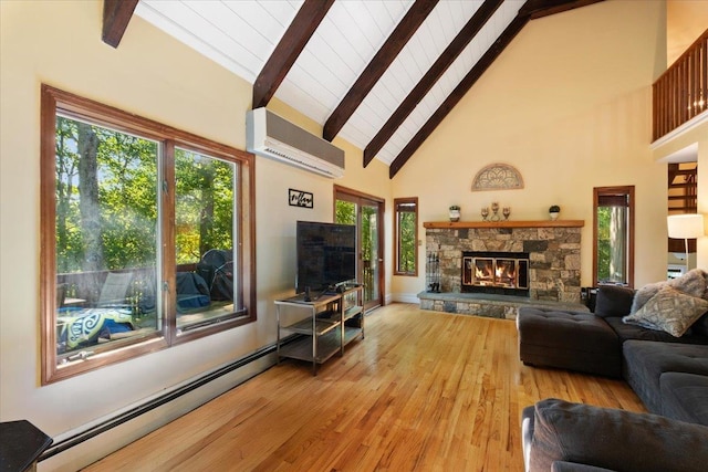 474 Swanson Dr, Thornwood, NY 10594 - living area featuring a baseboard radiator, a wall mounted AC, beam ceiling, high vaulted ceiling, and a stone fireplace
