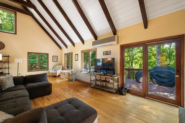 474 Swanson Dr, Thornwood, NY 10594 - living room with a wall unit AC, wood finished floors, high vaulted ceiling, healthy amount of natural light, and a wooden ceiling with exposed beams