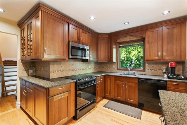474 Swanson Dr, Thornwood, NY 10594 - kitchen featuring black appliances, light wood finished floors, stone counters, brown cabinetry, and recessed lighting