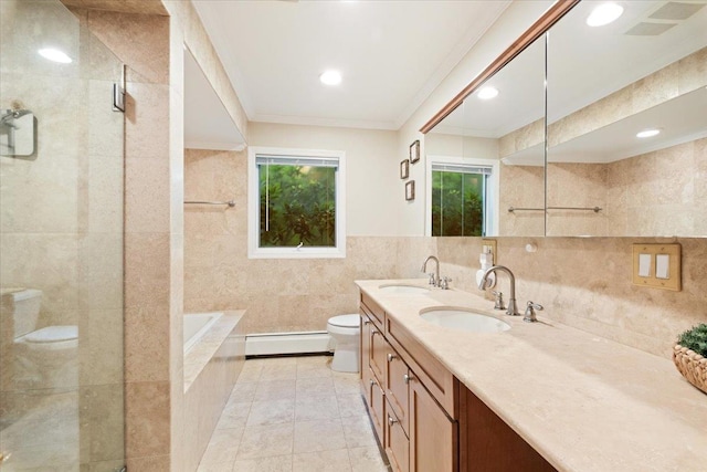 474 Swanson Dr, Thornwood, NY 10594 - full bath with a baseboard heating unit, tile walls, plenty of natural light, double vanity, and a garden tub