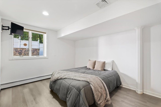 474 Swanson Dr, Thornwood, NY 10594 - bedroom featuring wood finished floors, a baseboard heating unit, and recessed lighting
