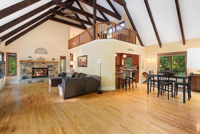 474 Swanson Dr, Thornwood, NY 10594 - living area featuring high vaulted ceiling, light wood-style floors, a fireplace, ceiling fan, and a wooden ceiling with exposed beams