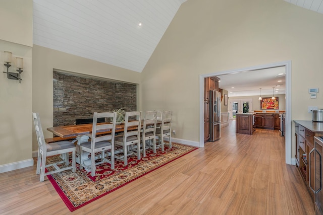 246 Cadman Ave, Babylon, NY 11702 - dining area featuring light wood-type flooring and high vaulted ceiling