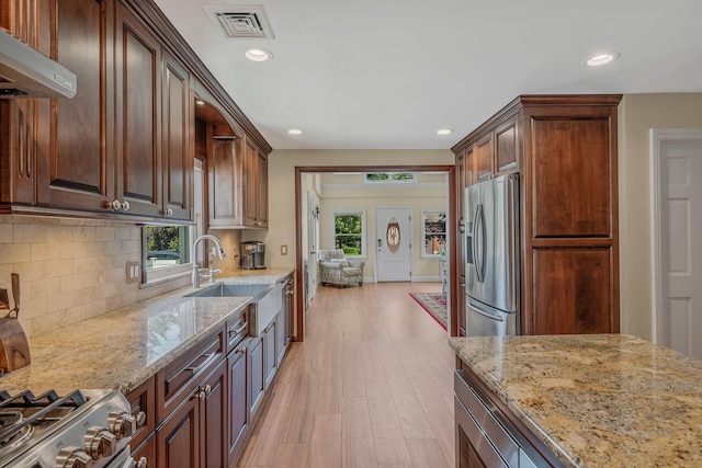 246 Cadman Ave, Babylon, NY 11702 - kitchen featuring stainless steel appliances, under cabinet range hood, recessed lighting, plenty of natural light, and light stone counters