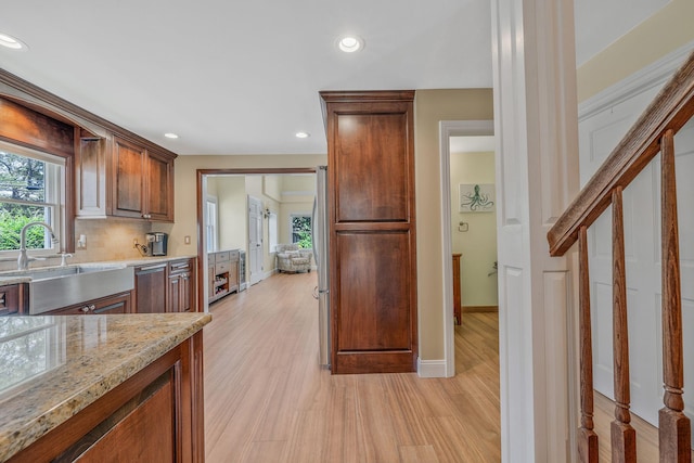 246 Cadman Ave, Babylon, NY 11702 - kitchen with recessed lighting, light wood-style flooring, light stone counters, and backsplash