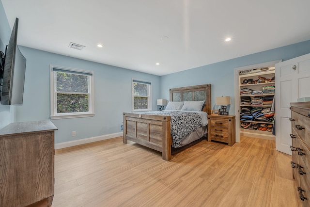 246 Cadman Ave, Babylon, NY 11702 - bedroom with light wood-style flooring, a spacious closet, recessed lighting, and a closet
