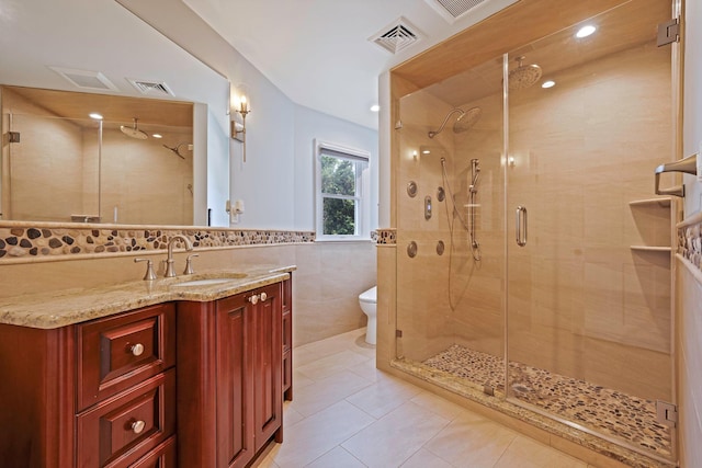 246 Cadman Ave, Babylon, NY 11702 - bathroom with tile walls, a stall shower, vanity, tile patterned floors, and wainscoting
