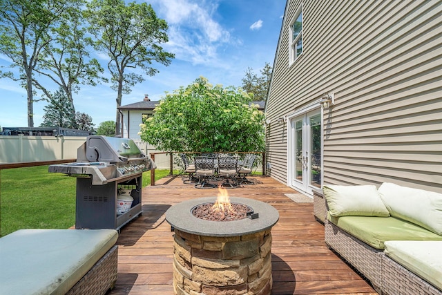 246 Cadman Ave, Babylon, NY 11702 - wooden terrace featuring french doors, a grill, outdoor dining space, and an outdoor living space with a fire pit
