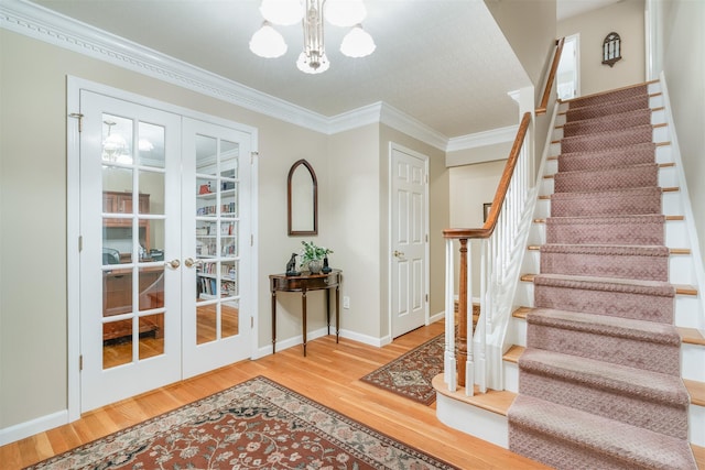 76 Warren St, Somers, NY 10589 - entrance foyer with french doors, stairs, wood finished floors, a chandelier, and crown molding