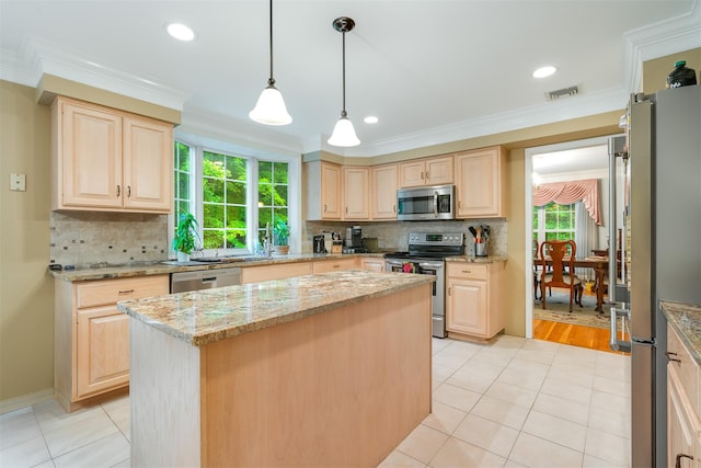 76 Warren St, Somers, NY 10589 - kitchen featuring appliances with stainless steel finishes, light brown cabinetry, light tile patterned floors, ornamental molding, and a center island