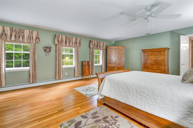 76 Warren St, Somers, NY 10589 - bedroom with wood finished floors, a baseboard heating unit, and ceiling fan