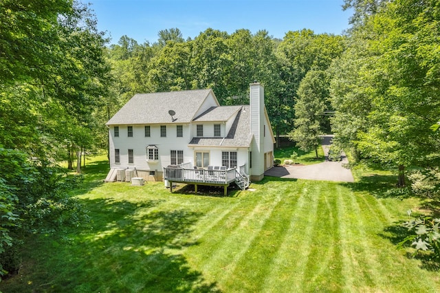 76 Warren St, Somers, NY 10589 - rear view of house with a deck, a chimney, a lawn, a shingled roof, and a view of trees