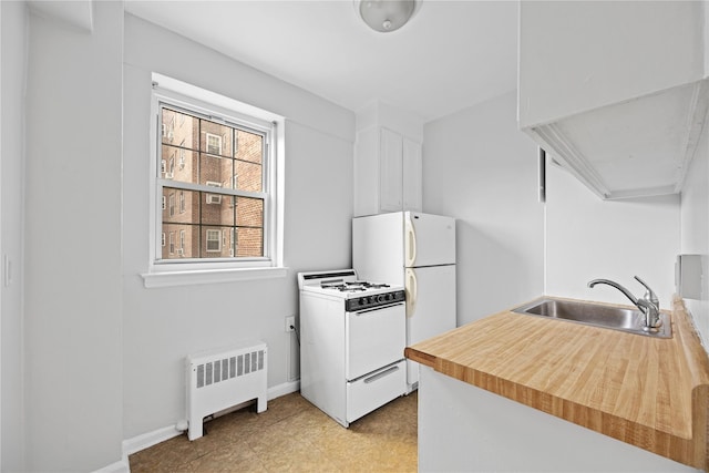 230 Pelham Rd Unit 3O, New Rochelle, NY 10805 - kitchen featuring radiator heating unit, white gas range oven, light countertops, and white cabinetry