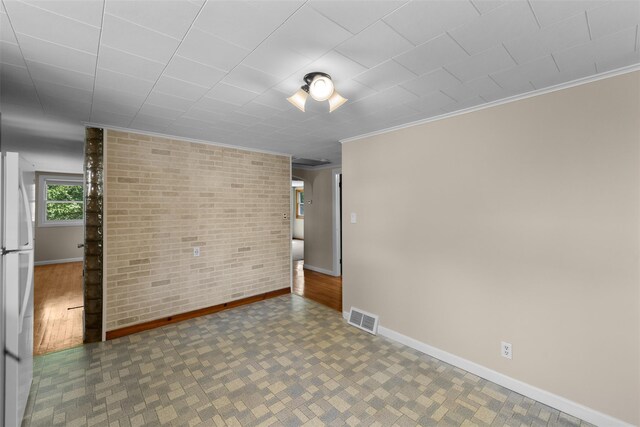 16 Stoll St, Port Jervis, NY 12771 - spare room featuring ornamental molding and brick wall