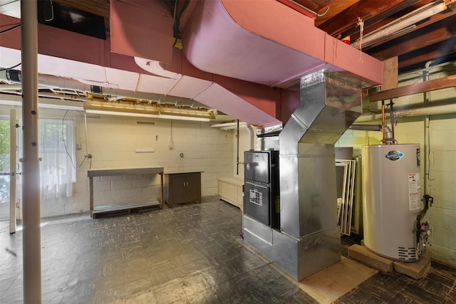 16 Stoll St, Port Jervis, NY 12771 - below grade area with water heater, concrete block wall, tile patterned floors, and heating unit
