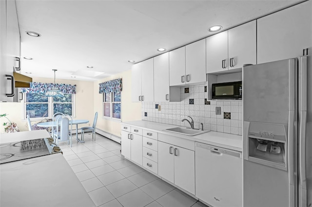 11 Rupert Pl, Melville, NY 11747 - kitchen featuring fridge with ice dispenser, white dishwasher, black microwave, light countertops, and backsplash