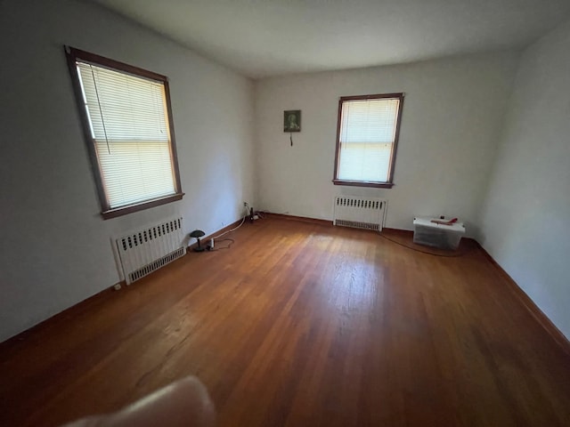 985 Ostrander Ave, Riverhead, NY 11901 - empty room with radiator heating unit and wood finished floors