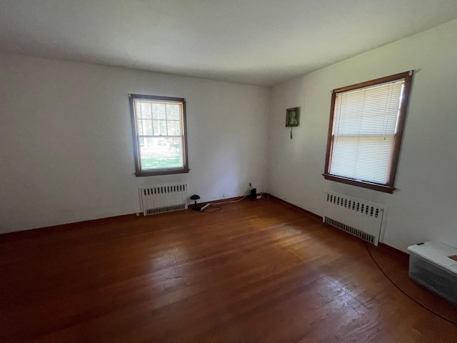 985 Ostrander Ave, Riverhead, NY 11901 - spare room with radiator and wood finished floors