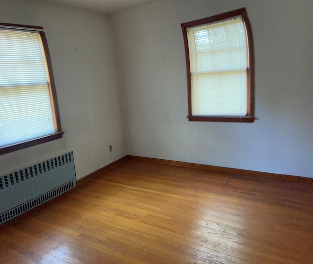 985 Ostrander Ave, Riverhead, NY 11901 - spare room featuring radiator and hardwood / wood-style flooring