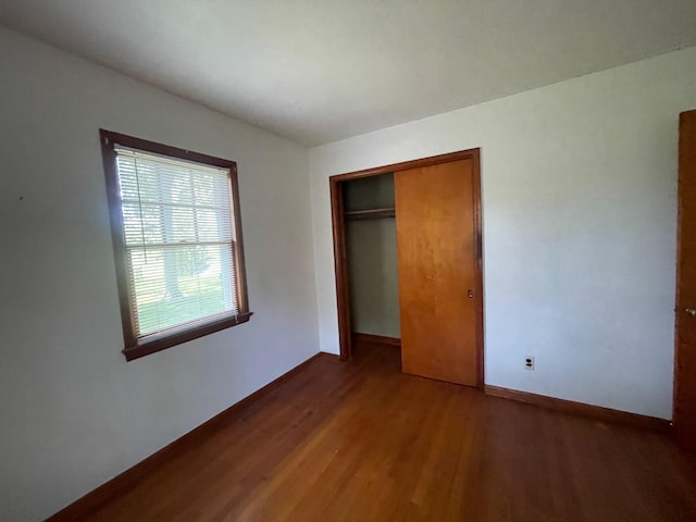 985 Ostrander Ave, Riverhead, NY 11901 - unfurnished bedroom featuring wood finished floors and a closet